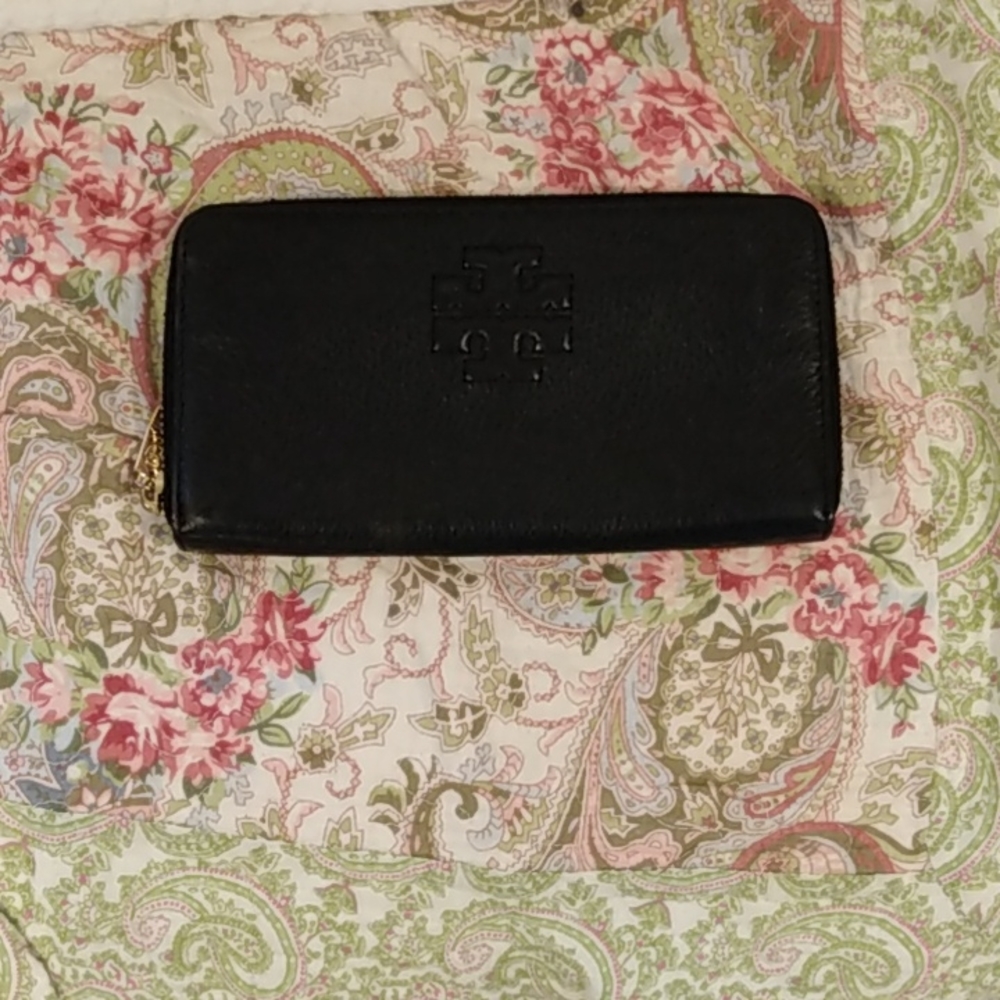 8 inches by almost 4 1/2 inches, black Tory Burch, leather, mint condition